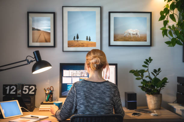 Woman working on computer in her home office during pandemic quarantine.